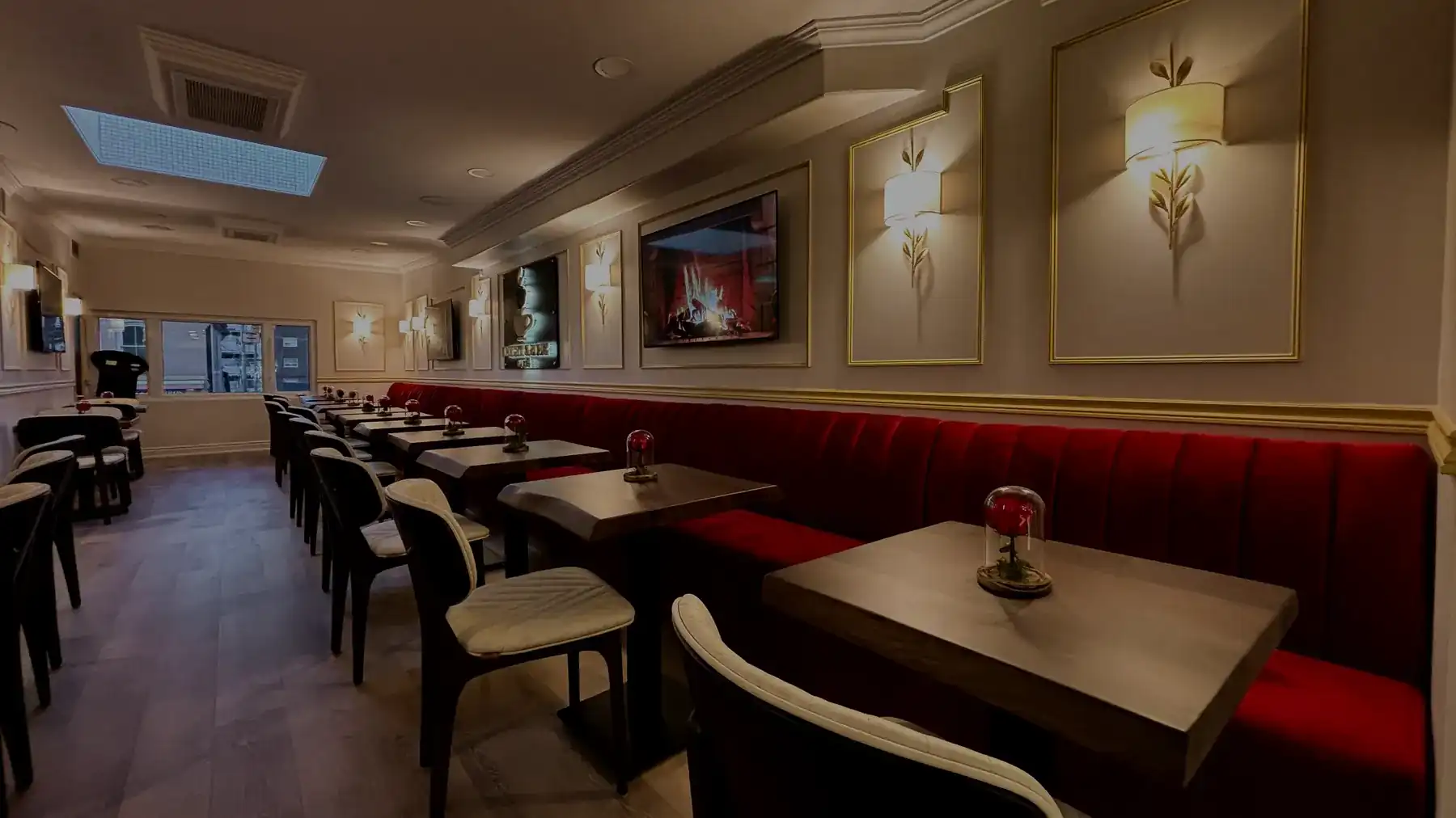 The Knight & Rose lounge after dark — banquettes and tables under low, warm light.