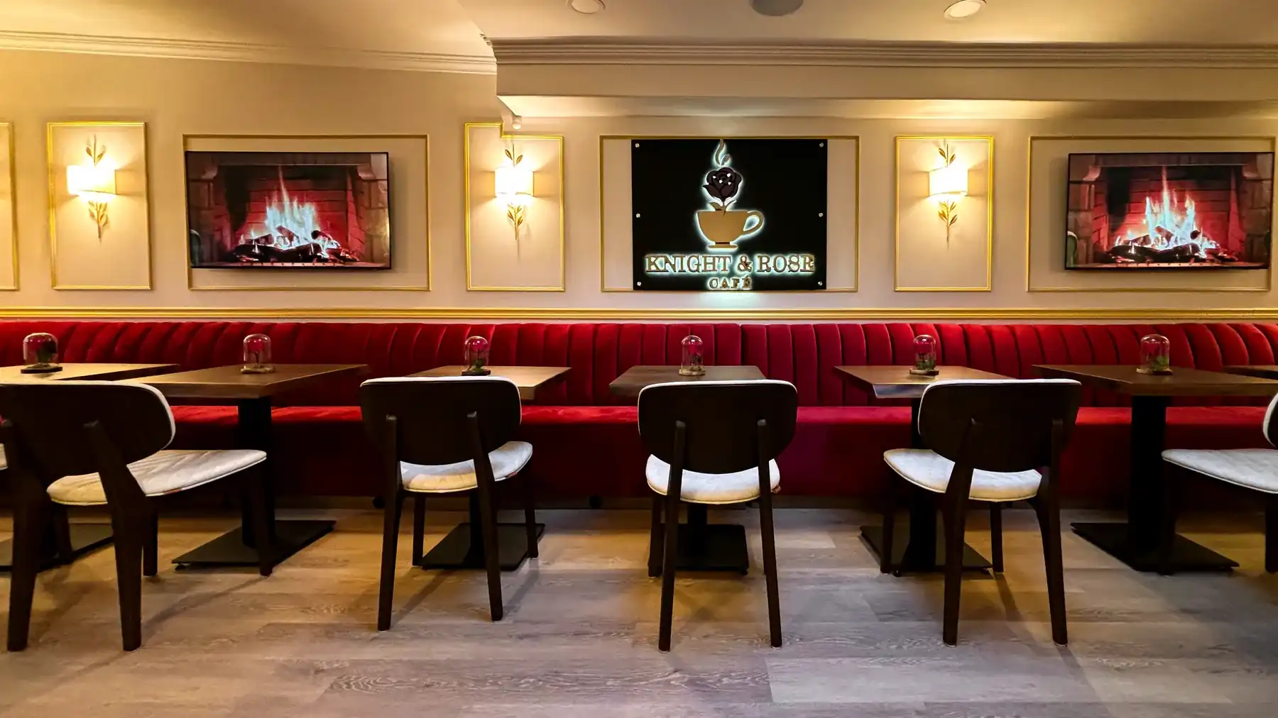 The Knight & Rose dining room set for an evening, banquettes running the length of the wall.